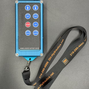 X8Pro wireless transmitter with blue anodized aluminum case, 8 control buttons, antenna, and carabiner clip attached to DH-Hydraulics branded lanyard.