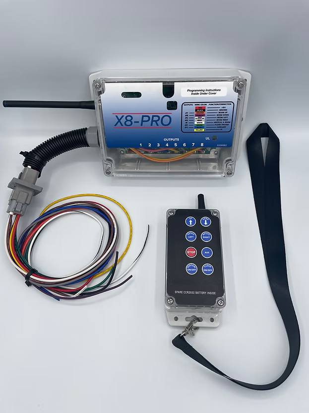 X8Pro wireless transmitter remote with 8 control buttons and antenna, shown with dimensions 2-9/16" wide by 5-11/16" tall, includes carabiner clip and lanyard strap.